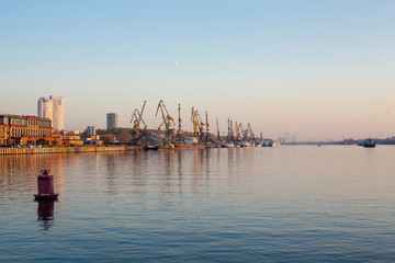 Building cranes on a river shore