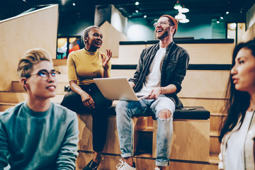Naklejka premium Successful group of diverse startupers enjoying together collaboration in modern workspace for brainstorming meetings, happy multiracial hipster students discussing ideas for university project