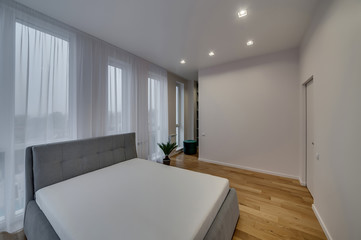 Fototapeta na wymiar Interior of a modern loft style apartment. Spacious bedroom