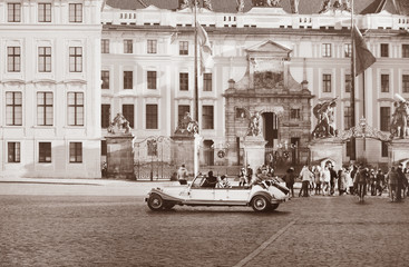 Prague view in vintage style. Beautyful retro car on the city square