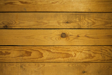 Horizontally arranged light wood boards with knots and scuffs.