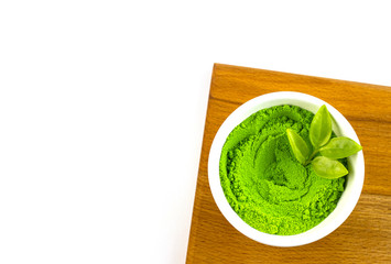 dry green tea powder matcha tea with whole leaves, isolate on a white background
