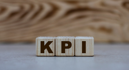 concept of the word KPI on cubes on a gray background with letters