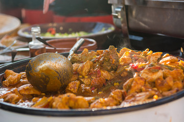 Cheff cooking delicious meat dish in a large pot.
