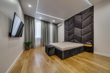 Interior of a modern loft style apartment. Spacious bedroom