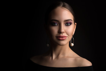 Fototapeta premium portrait of a beautiful young woman on a black background. Copycpase