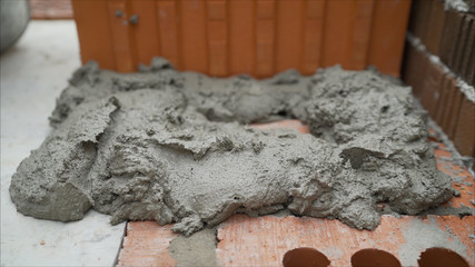 Laying red ceramic blocks at a construction site. CERAMIC BLOCKS FOR BUILDING A HOUSE. Warm...