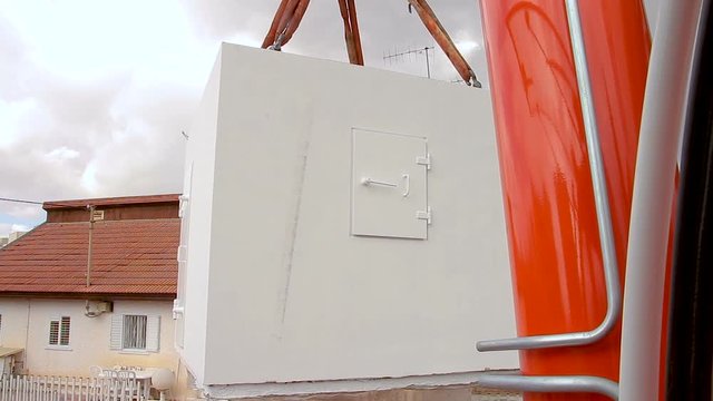 Mobile bomb shelter being deployed in a house in Israel. This is an extra Fortified Room that helps the house residents to be protected from rocket fire attacks. It called Migunit" or "Merkhav Mugan""