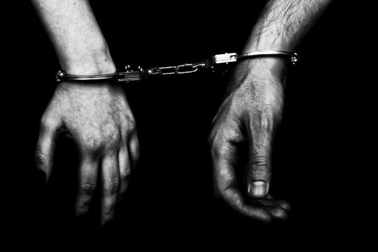 men and women cuffed hands together