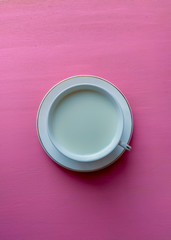 empty white plate and pink background 