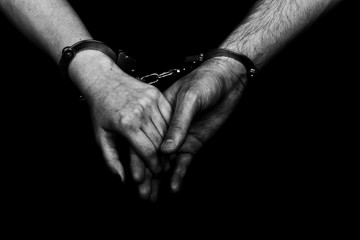 men and women cuffed hands together