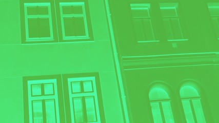 Green wall with windows. Fragment, details. Shades of green, toned photo, 16:9 panoramic format