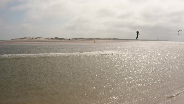 People kite sufring with hard wind on the ocean