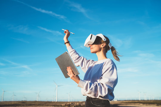 Woman having VR experience in wind farm
