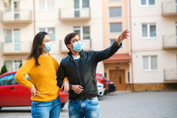 Man and woman wearing medical mask outdoors. Coronavirus epidemic.