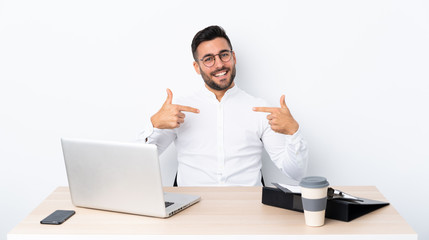 Young businessman in a workplace proud and self-satisfied