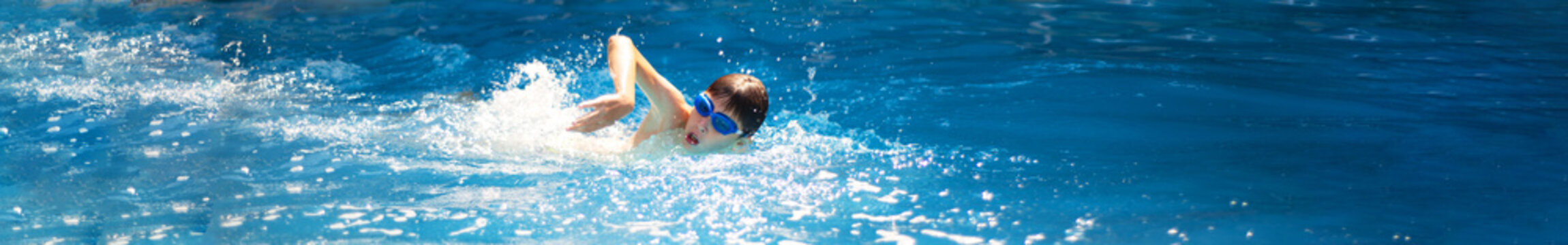 Panoramic image of a swimmer athlete crawling.