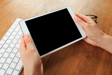 female hands holding smart phone on wooden background  , place for your text  .