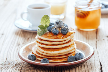 Homemade pancakes, fresh summer berries, coffee and juice