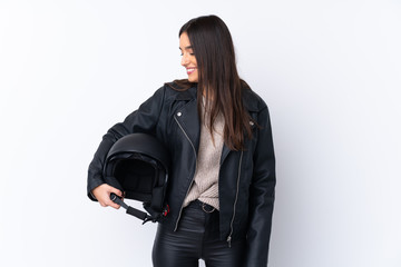 Young brunette woman with a motorcycle helmet over isolated white background with happy expression