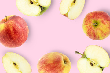Ripe red apples on pink background. Top view. Flat lay.