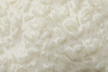 Delicious rice pudding as background, closeup view