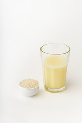 Dairy alternative. Rice milk in a high glass on white background.