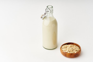 Oat milk in a glass bottle. Dairy alternative. Healthy vegan protein drink