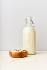 Oat milk in a glass bottle. Dairy alternative. Healthy vegan protein drink
