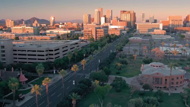 Aerial flying over downtown Phoenix city skyline at sunset. Phoenix, Arizona, USA. 
