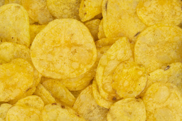 Crispy potato chips snack texture background. Top view. Flat lay