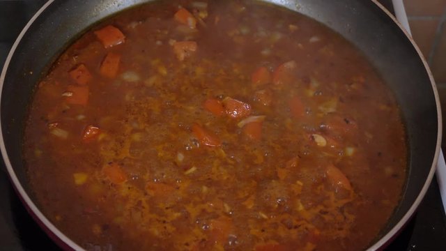 Sauce Cooking Red Tomato in a Boiling Pan and Stir Close up