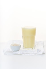 Dairy alternative. Rice milk in a high glass on white background.