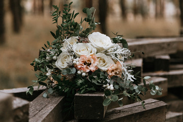 wedding bouquet of roses on a wooden fence