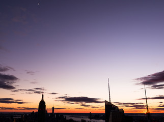 Fototapeta premium New York City silhouette at the rare moment when sun and moon are visible in the frame