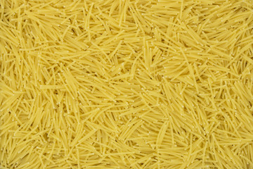Uncooked vermicelli pasta texture background. Traditional Italian food.