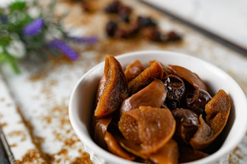 Sweet and soft dried Apple and rose hips prepared for dessert, decorated with a sprig of lavender and dry fruits on an unusual white and rusty metal background
