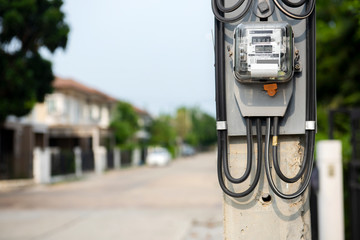 Electric power meter electric meter, watt hour meter, blurry background, housing estate