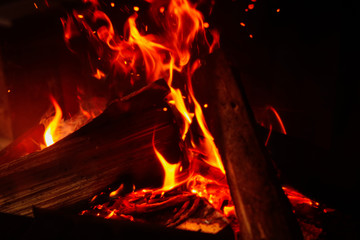 Fototapeta na wymiar Fireplace with burning wood, closeup view. Winter vacation