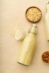 Dairy alternative. Rice milk in a bottle on beige background. Healthy protein vegan drink.