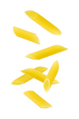 Falling penne pasta. Flying yellow raw macaroni over white background. - obrazy, fototapety, plakaty