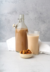 Chocolate almond milk with a bowl of raw almonds. Healthy vegan protein drink. Dairy alternative