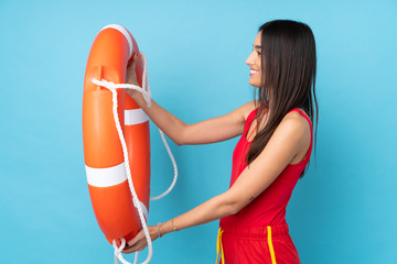 Lifeguard woman over isolated blue background with lifeguard equipment and with happy expression