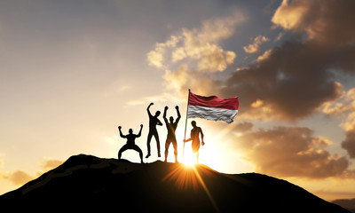 A group of people celebrate on a mountain top with Indonesia flag. 3D Render