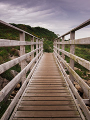 Fototapeta na wymiar Wooden walkway in sand dunes in Northern Ireland 