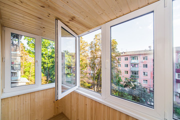 White metal-plastic windows of balcony in modern apartment