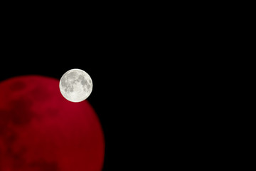 Big full bright dramatic white moon with red reflection background. Perigee night, lunar closest to...