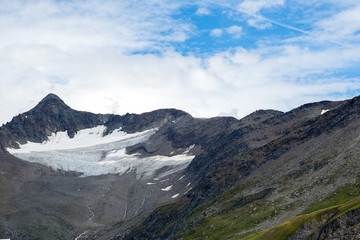 The mountains of Switzerland, the summits of the mountains with snow in summer