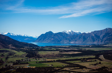 Stunning aerial image of the Wanaka fields with the snowy Mount Aspiring in the background on a...