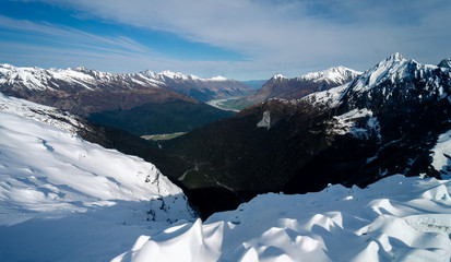 Stunning aerial image of the mouth of the glacier at Lake Wanaka surrounded by snow capped...